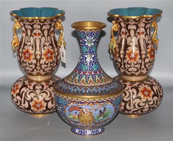 A pair of Chinese pink ground cloisonne enamel vases and a similar blue ground vase 30cm